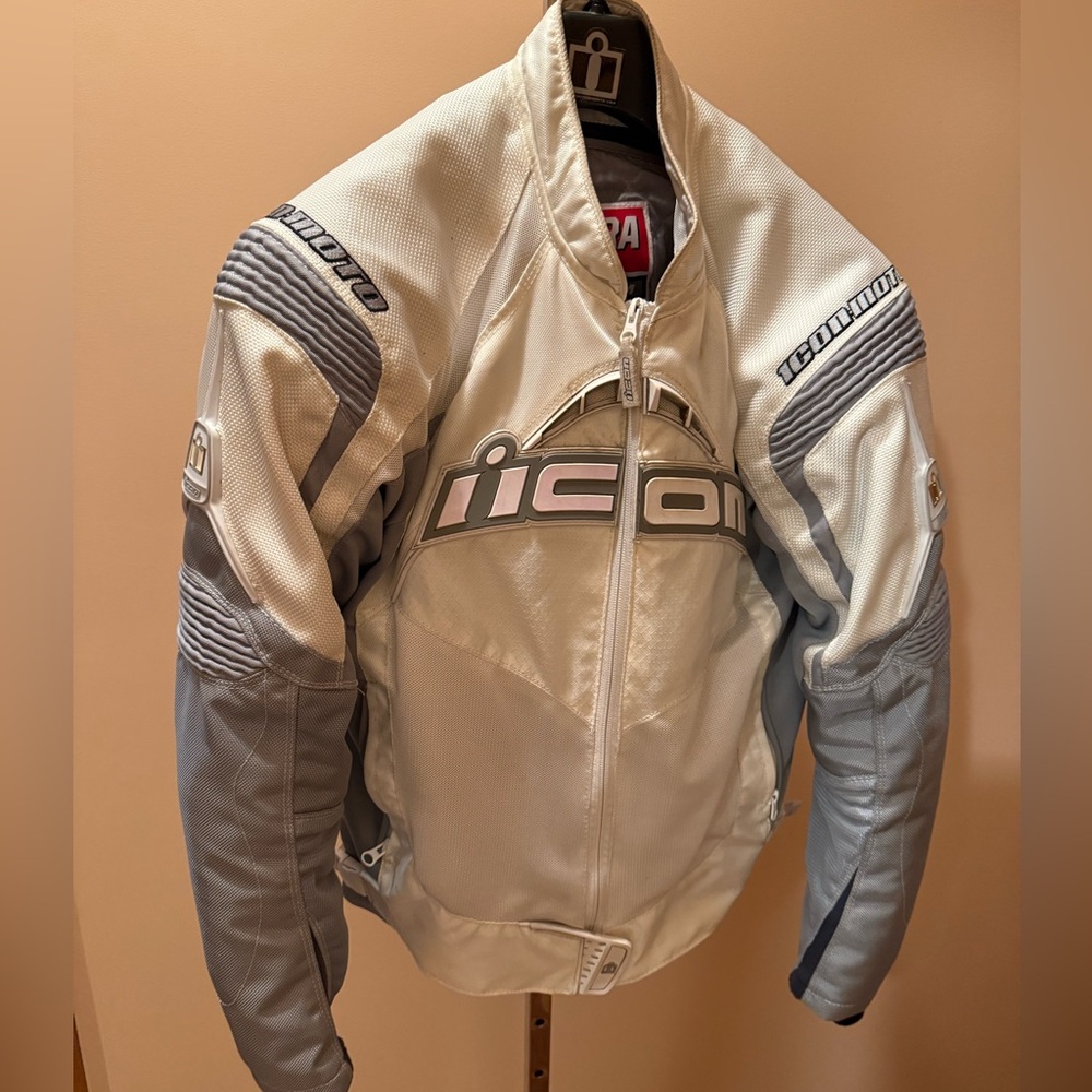 ICON Contra motorcycle jacket in white and grey with armor and original hanger